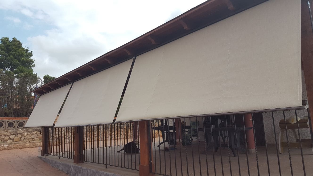 Toldo tipo cofre a color blanco en casa de madera patio